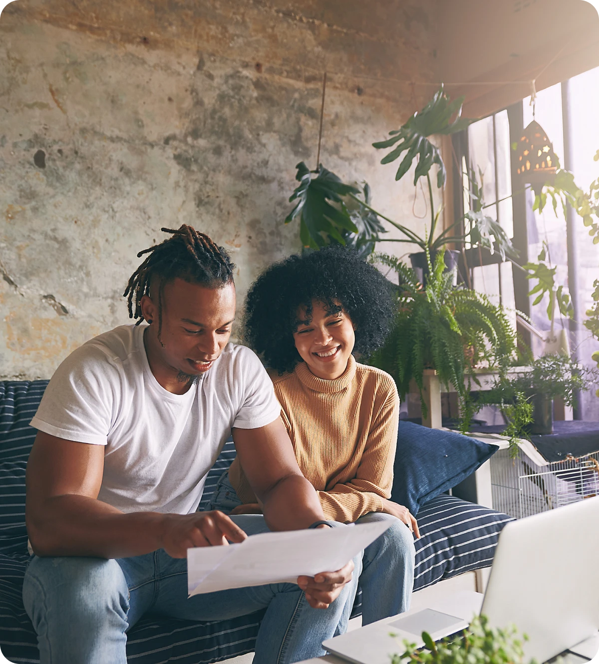 Happy couple with paperwork at home