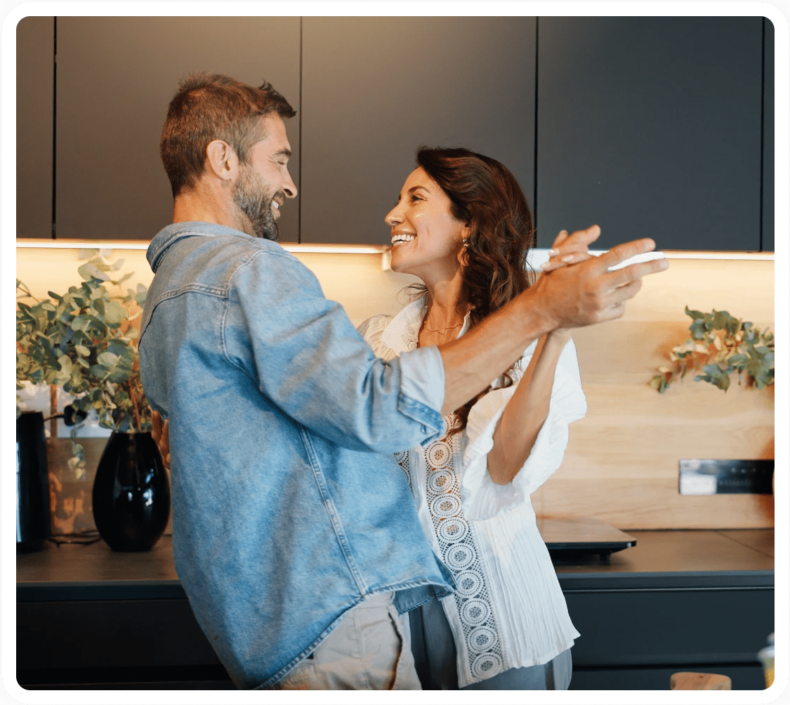Couple dancing happily in kitchen