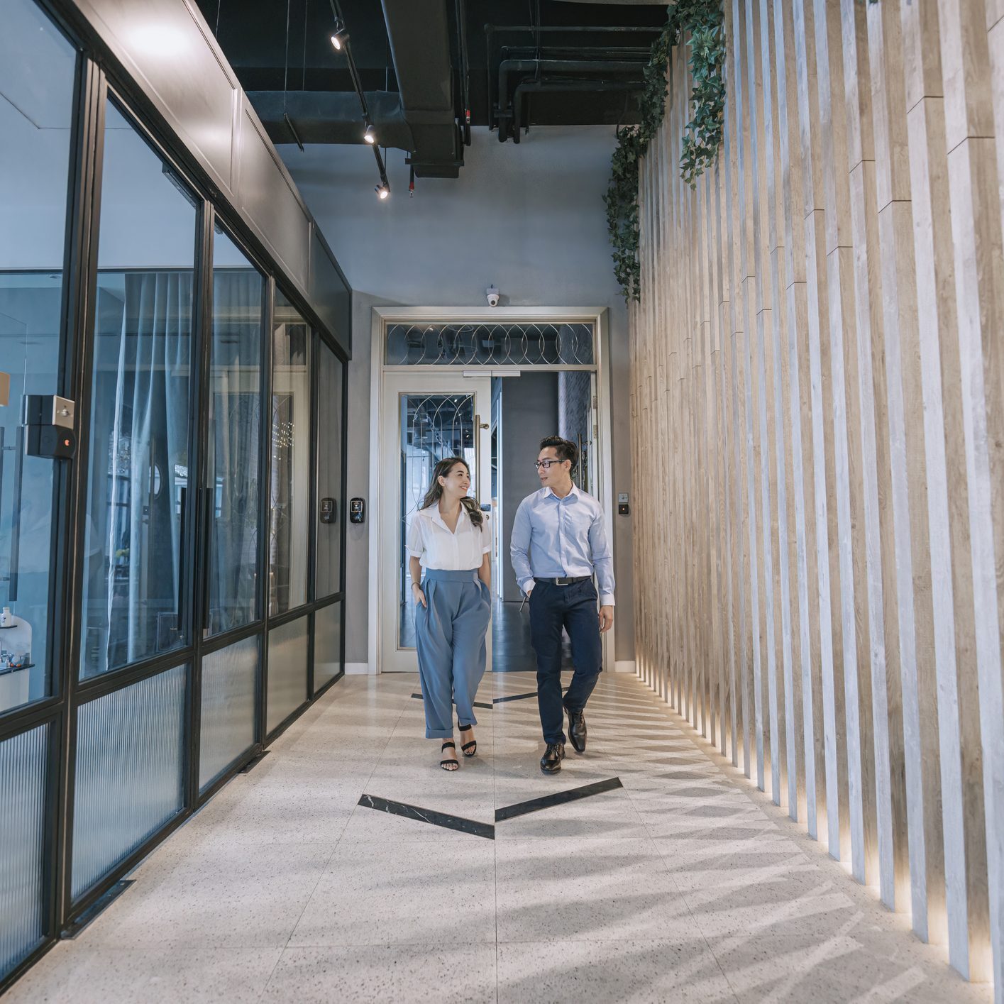 People walking in modern office hallway