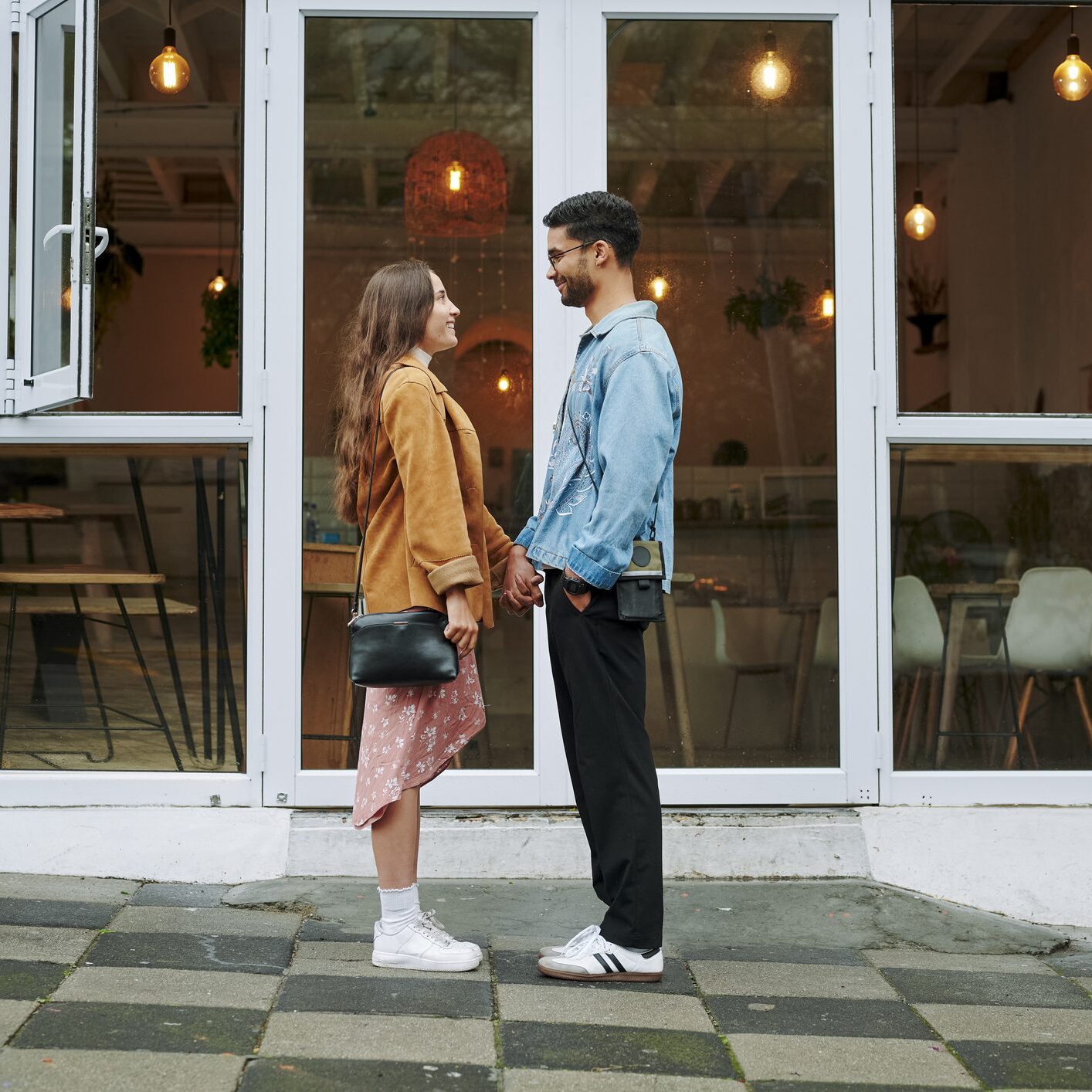 Couple standing outside a café